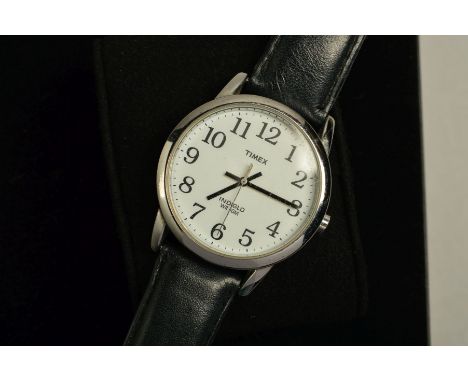 A TIMEX WRISTWATCH, the circular head with white face, Arabic numerals, black hands and black leather strap, with a Bamford W