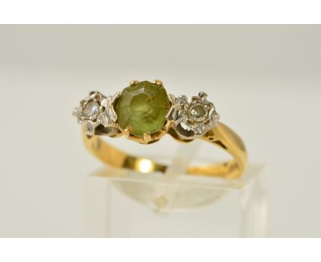 AN 18CT GOLD PERIDOT AND DIAMOND RING, designed as a central circular peridot with a single cut diamond to either side, each 