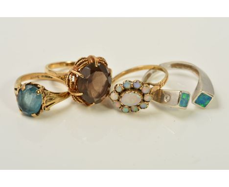 FOUR GEM SET RINGS, the first claw set with an oval smoky quartz, the second an oval opal cluster, the third claw set with an