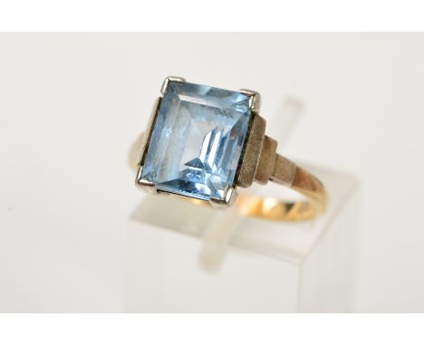 A GEM RING, designed as a central rectangular gem assessed as blue spinel, to the stepped shoulders, stamped 9ct, size M, app