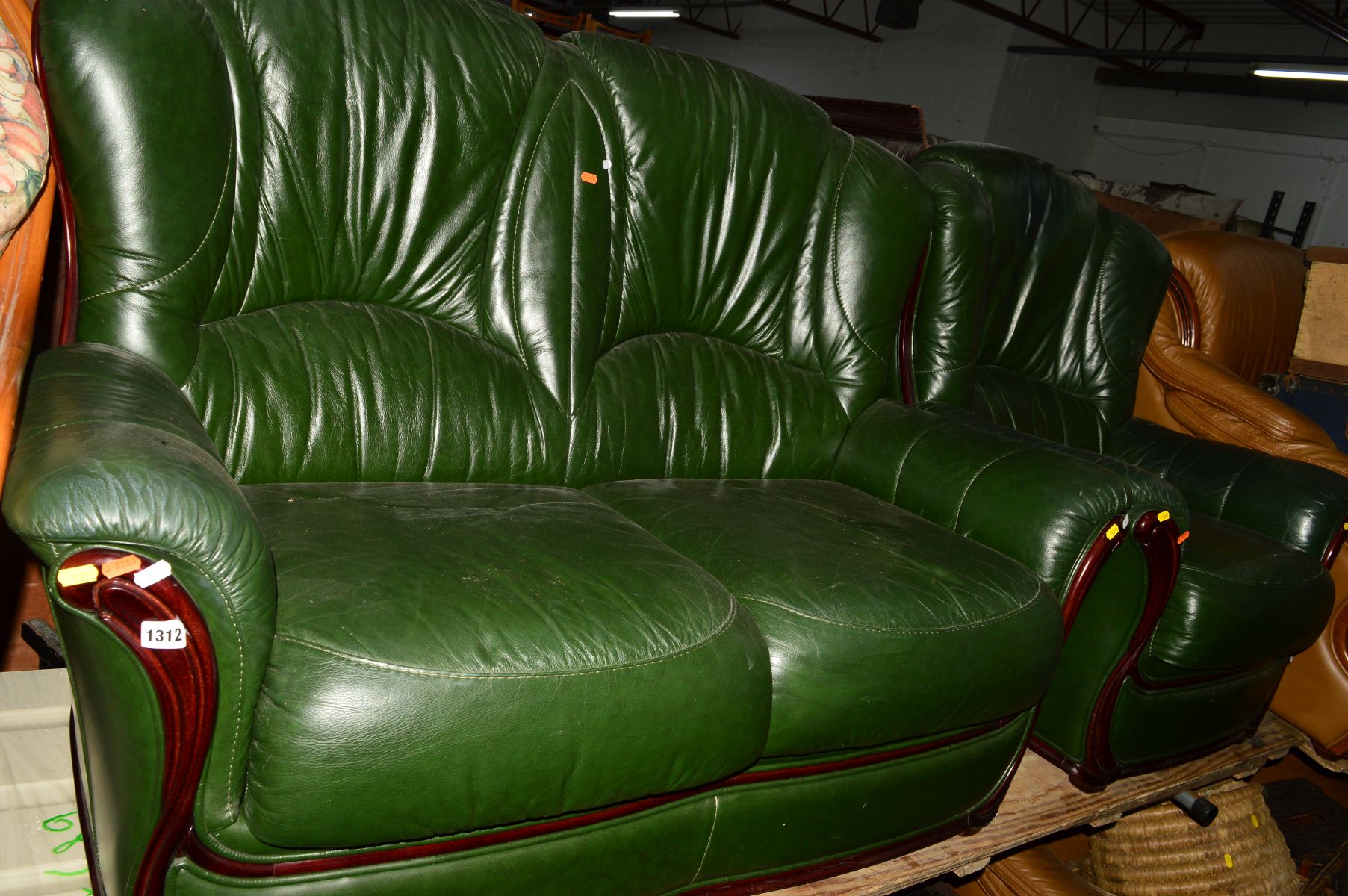 A GREEN LEATHER TWO PIECE LOUNGE SUITE, comprising a two seater settee