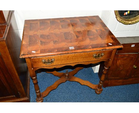 A REPRODUCTION OAK LOWBOY, with a multi wood specimen geometric top, single drawer, raised on turned legs united by a shaped 