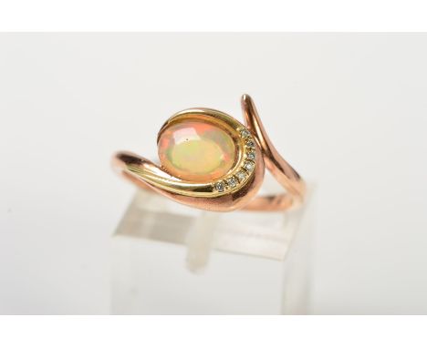 A 9CT GOLD CLOGAU OPAL AND DIAMOND RING, designed as an oval jelly opal cabochon within an asymmetric crossover setting set w