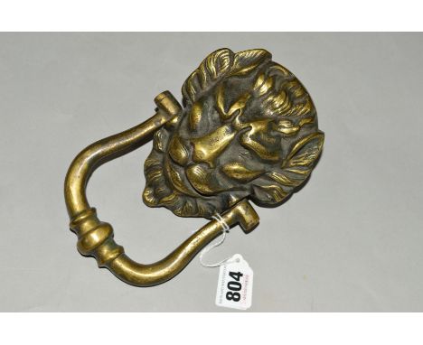 A HEAVY BRASS DOOR KNOCKER, shaped as a Lions head
