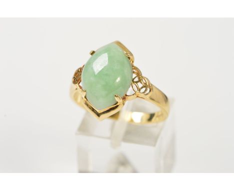 A 14CT GOLD JADE RING, designed as a marquise shape jade cabochon, to the openwork shoulders, with 14ct hallmark for Birmingh