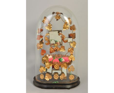 A VICTORIAN GLASS DOME, on an ebonised base, containing a gilt metal arrangement with bird and wreath finial above six rectan