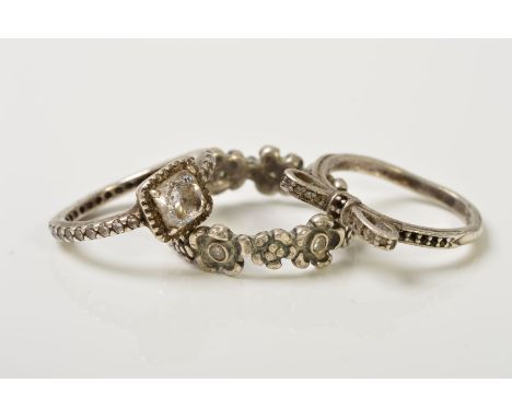 THREE PANDORA RINGS, the first a band ring designed as flowers set with colourless cubic zirconias, the second a bow ring set