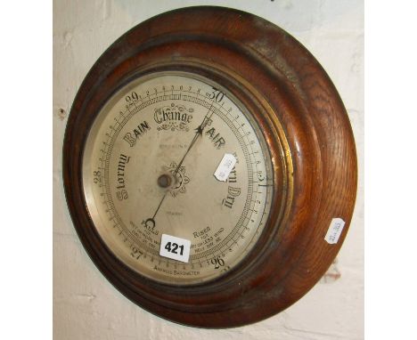 Oak-framed circular aneroid barometer, stamped Botley & Lewis of Reading