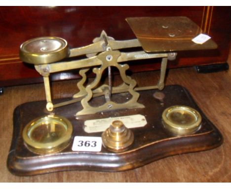 Victorian brass letter scales on shaped wood base, with weights