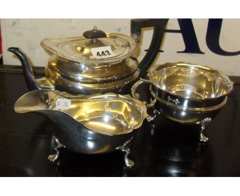 Silver teapot (Sheffield 1912), a silver sauce boat (Chester), and a silver sugar bowl (Sheffield 1915)