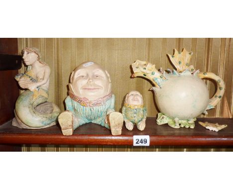 Two Amanda Popham pottery figurines of Humpty Dumpty, a Dragon teapot (A/F), and a mermaid holding a fish  