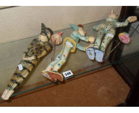 Three Amanda Popham Studio Pottery figures - a man with bird mask wall pocket, a lady spinning plates, and a teapot figure (R