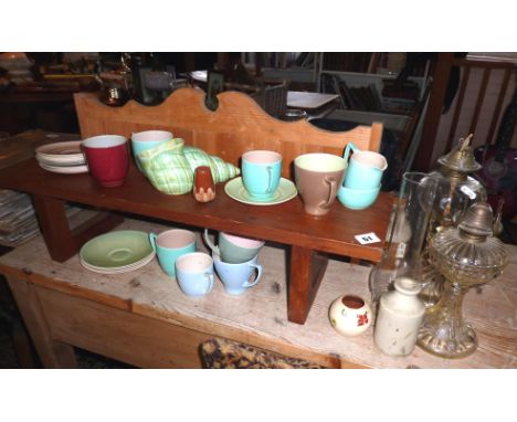 Collection of Branksome pottery coffee & teacups, a pine shelf, a teak display shelf and two oil lamps