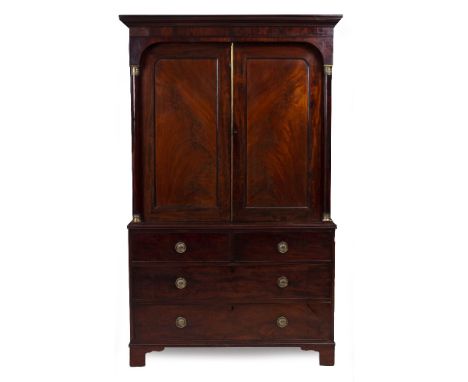 A 19TH CENTURY MAHOGANY LINEN CUPBOARD with twin panelled doors, pilaster column supports above two short and two long drawer