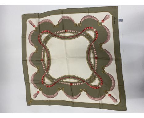 A COLLECTION OF TWO MUST DE CARTIER SILK SCARVES, a Hermes silk scarf and a Hermes beret and further scarf Condition: the Her
