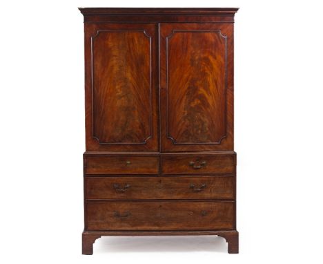 A 19TH CENTURY MAHOGANY LINEN PRESS with twin panel doors above two short and three long drawers with brass swan neck handles