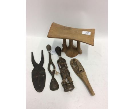 A MIXED LOT OF TRIBAL ITEMS including two masks, a doll and a carved wooden spoon together with an East African carved wood h