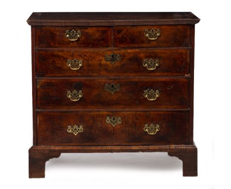 AN 18TH CENTURY WALNUT VENEERED CHEST OF TWO SHORT AND THREE LONG DRAWERS with brass handles and raised on bracket feet, 96.5