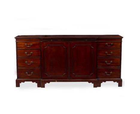A REPRODUCTION GEORGIAN STYLE MAHOGANY BREAKFRONT SIDEBOARD with twin panelled doors flanked by single drawers and cupboards 