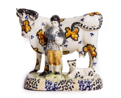 A LATE 18TH CENTURY PEARL WARE COW FIGURINE with milkman and calf, with brown and blue glaze, 16cm wide x 15cm high Condition