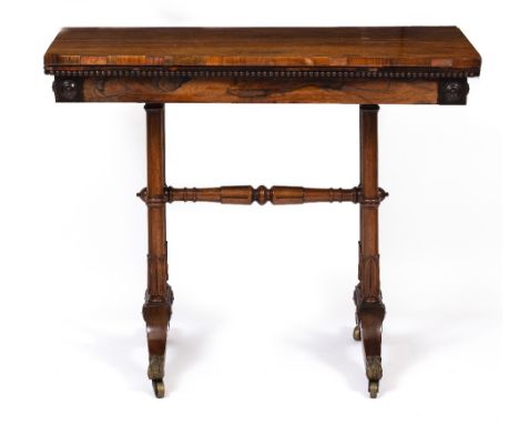 A WILLIAM IV ROSEWOOD RECTANGULAR TOPPED FOLD OVER CARD TABLE with green baize lined interior, carved supports and splaying l