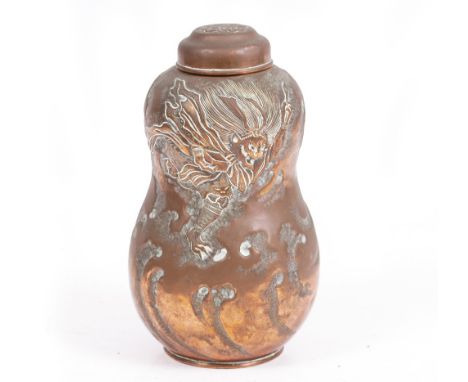AN EARLY 20TH CENTURY JAPANESE COPPER TEA CADDY of double gourd form with impressed warrior decoration, 11cm wide x 18cm high