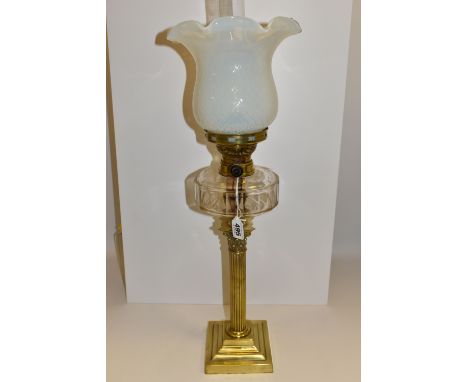 A VICTORIAN STYLE OIL LAMP, brass Corinthian column, stepped square base, clear glass facet cut reservoir and a Uranium glass