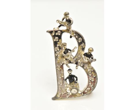 A 'BEATLES' BROOCH,  a large white metal 'B' brooch with four figures playing instruments, signed 'Exquisite' approximate len
