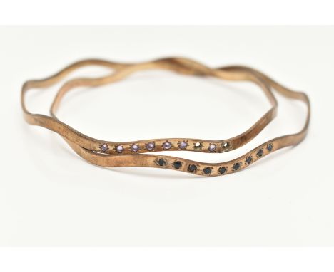A PAIR OF MATCHING 9CT GOLD BANGLES, wave design bangles, one set with nine star set blue spinel's, the second set with seven