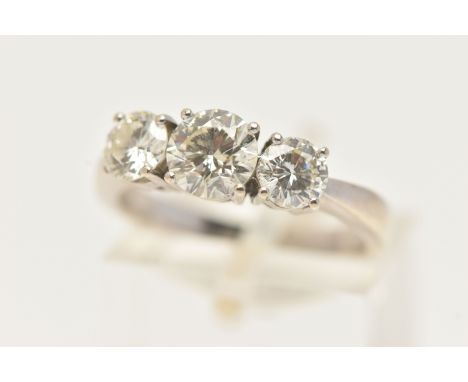 AN 18CT WHITE GOLD THREE STONE DIAMOND RING, designed as three brilliant cut diamonds in claw settings, assessed as SI1-SI2 c