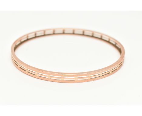 A ROSE METAL BANGLE, solid bangle with pierced and engine turned pattern detail, approximate width 5.5mm, approximate interna
