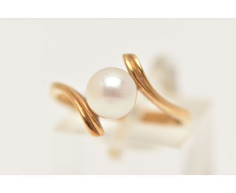 A CULTURED PEARL CROSS OVER RING, designed as a central cultured pearl to the cross over band, stamped 750, ring size M 1/2, 