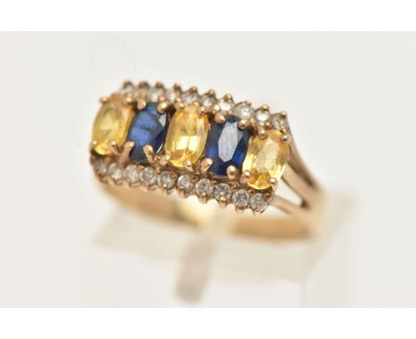 A 9CT GOLD GEM SET RING, set with five alternating oval cut blue and yellow sapphires, each in a four claw setting, between r