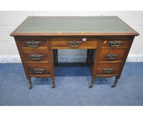 A 20TH CENTURY OAK AND MAHOGANY KNEEHOLE DESK, with a green leather writing surface, an arrangement of seven drawers, raised 