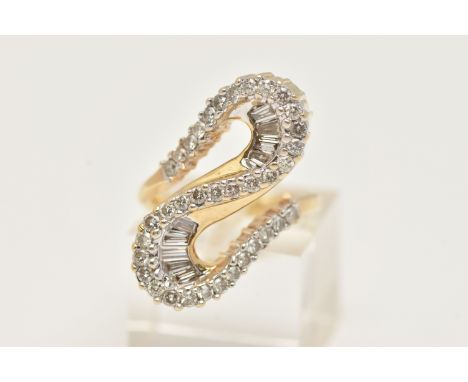A MODERN DIAMOND DRESS RING, the ring is of an abstract design, set with graduating tapered baguette cut diamonds and modern 