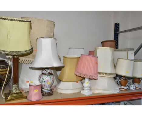 A LARGE QUANTITY OF TABLE LAMPS AND LIGHT SHADES, comprising a pair of turned wood bedside lamps, a tall teak and brass colum