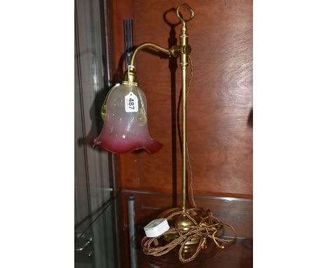 A BRASS RISE AND FALL TABLE LAMP, with cranberry and uranium glass shade, with frilled rim and applied details, height 51cm (