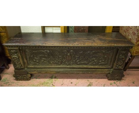 CASSONE, late 16th/early 17th century Italian walnut with hinged top above a foliate scroll and portrait carved panel front (