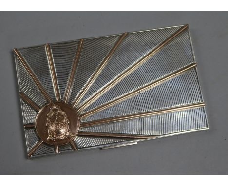 An Art Deco style white metal and gilt engine-turned cigarette case, with gilt sunburst motif bearing the seal of Maharajah H
