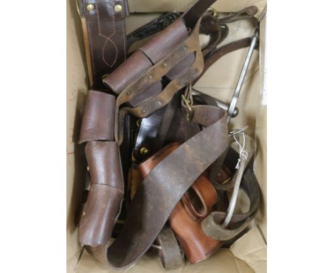 A group of leather bridles, stirrups and leather ammunition pouches