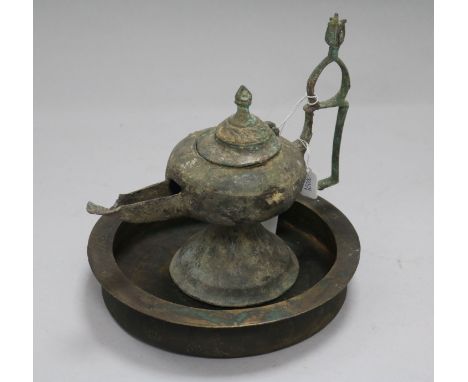 An Islamic bronze incense burner and an oil lamp