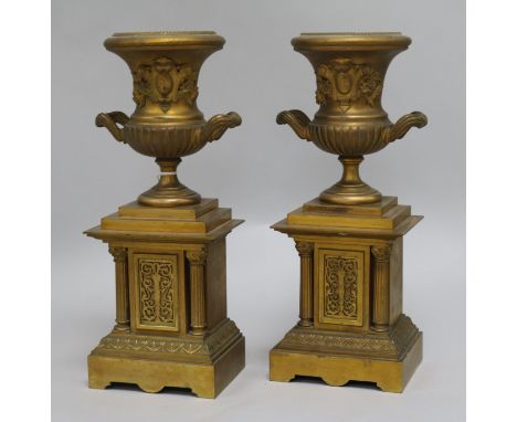 A pair of bronze urns on stand