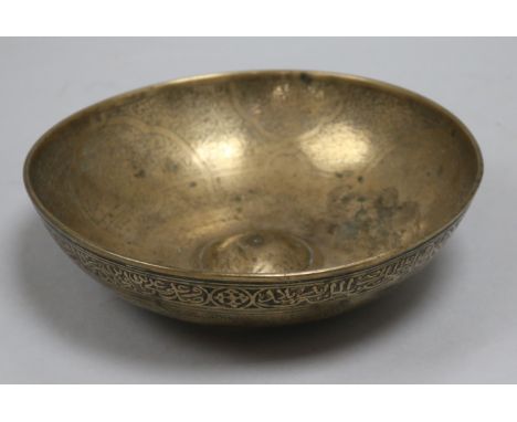 An Islamic bronze magic bowl with incised Koranic inscriptions within geometric motifs, Dia 7.5in (wear to interior)