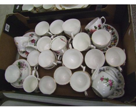 A large collection of floral decorated cups and saucers: 
