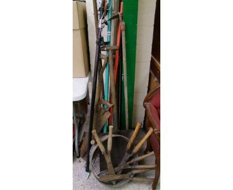A collection of vintage gardening tools: to include saw, shovels, forks, hand shears etc