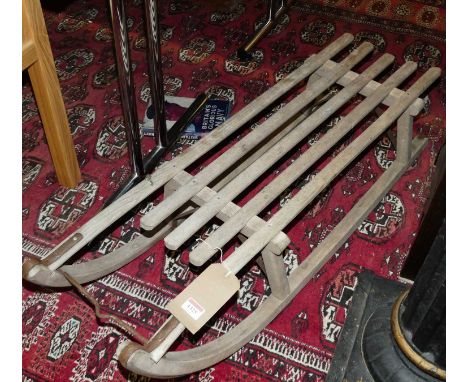 A faded oak and metal mounted child's sled, length 105cm 