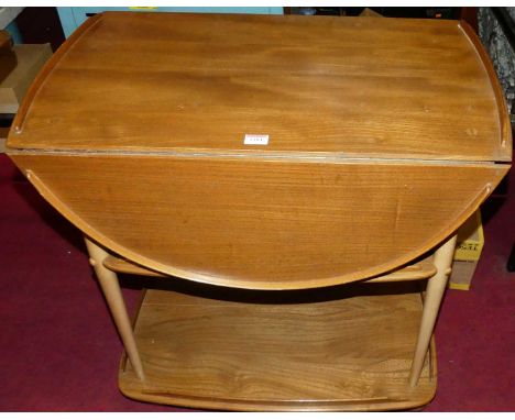 An Ercol light elm drop-flap three-tier tea trolley, raised on roller castors, width 73cm