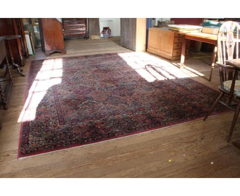 A Karastan 'Kirman' design carpet, with all over shaped panel design filled with floral sprays, within a foliate border, 369c