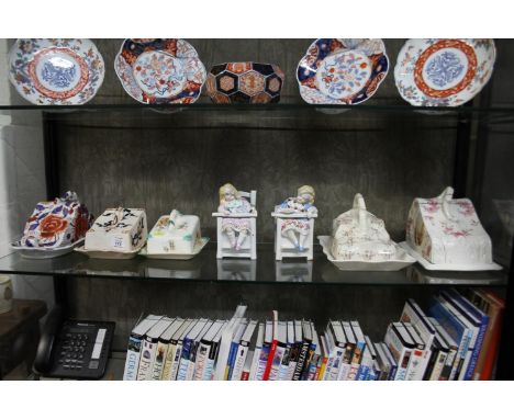 Five ceramic cheese wedges and two glazed bisque boxes in the form of children asleep in chairs, as found (7)