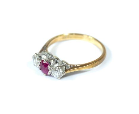 An 18 carat gold diamond and ruby three stone ring, size N&nbsp;